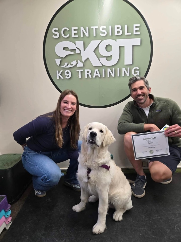 A client and their dog with a graduation certificate at Scentsible K9 Training in Meridian, Idaho